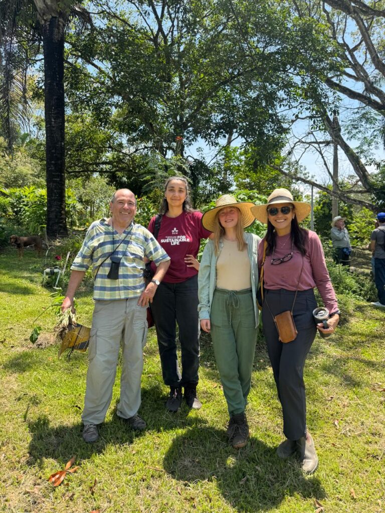 Four people smiling at the camera.