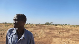 Innovative farmer in front of his field of half moons in Burkina Faso. Photo credit: Anneli Sundin